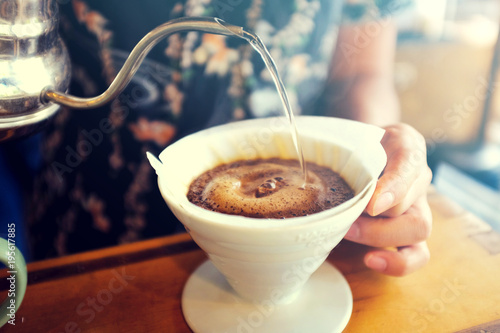 Hand Drip Coffee, Barista pouring hot water on roasted coffee ground with filter