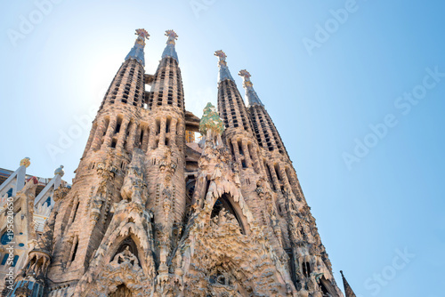 La Sagrada Familia - View to the facede of cathedral under bright sun, designed by Antonio Gaudi in Barcelona, Spain