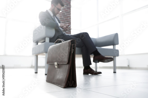 Businessman in his office with briefcase © ASDF