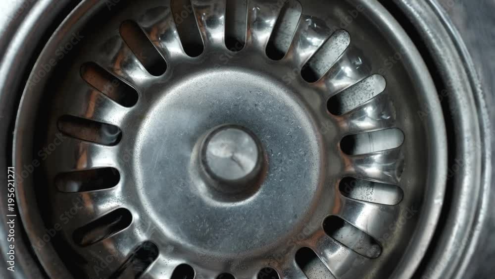 Streaming water in sink. Water stream going down the drain.
Streaming water in sink. Water stream going down the drain.