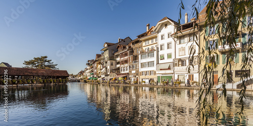 Switzerland, Canton of Bern, Thun, river Aare, old town with Aarequai and sluice bridge photo