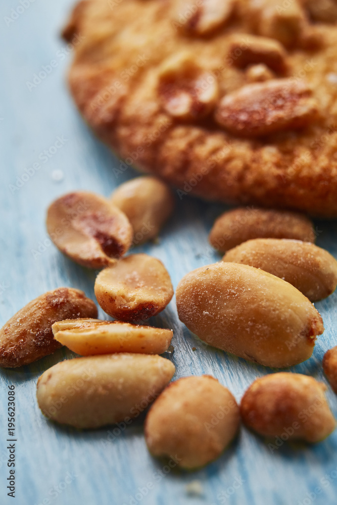 close-up of caramelized roasted peanuts on blue wooden background