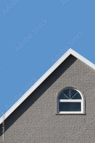 Grey house and blue sky