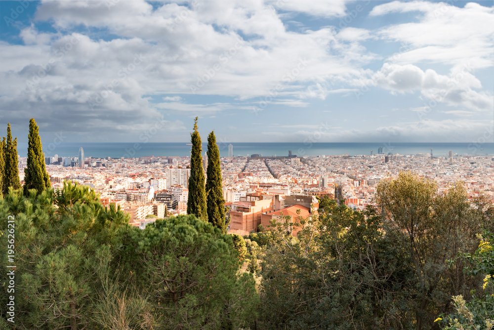 high angle view of Barcelona cityscape against sea and sky on sunny day