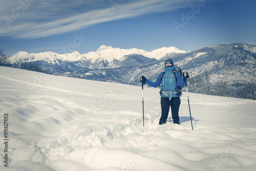 A Hiker trekking in winter landscape.