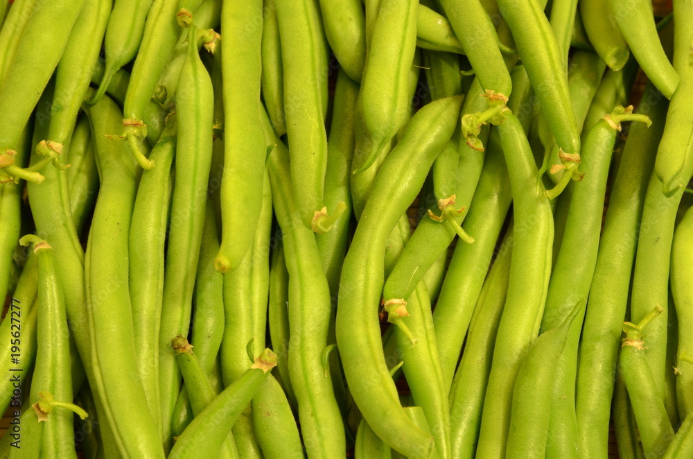 Bean pods are stacked parallel to each other as a background.
Bean pods are stacked parallel to each other as a background.