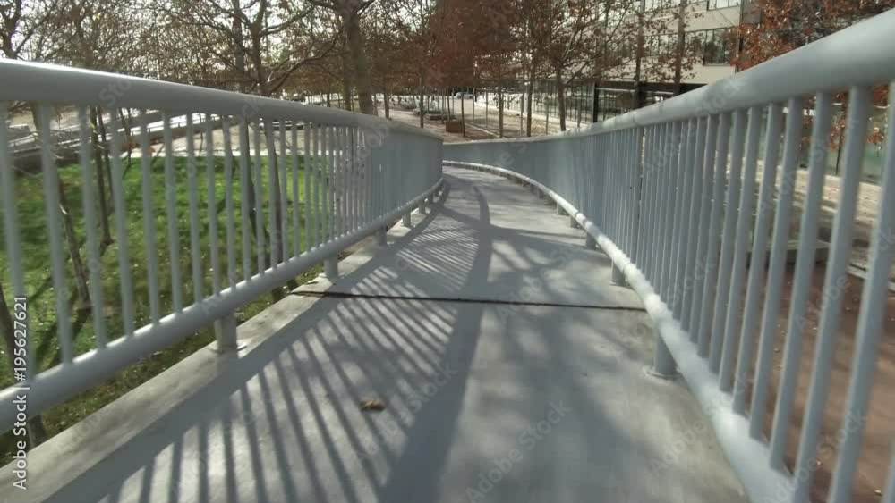 Pedestrian bridge without people.
Walking on a footbridge, going down toward left. Smooth camera movement:point of view. Pedestrian bridge without people.
Walking on a footbridge, going down toward left. Smooth camera movement:point of view.