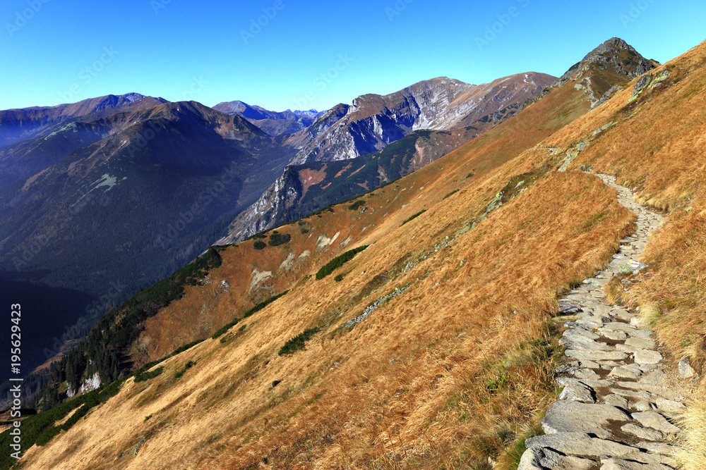 Poland, Tatra Mountains, Zakopane - Posredni Wierch Gryczkowy and Goryczkowa Czuba peaks with Czerwne Wierchy peaks and Western Tatra mountain range panorama in background Poland, Tatra Mountains, Zakopane - Posredni Wierch Gryczkowy and Goryczkowa Czuba peaks with Czerwne Wierchy peaks and Western Tatra mountain range panorama in background