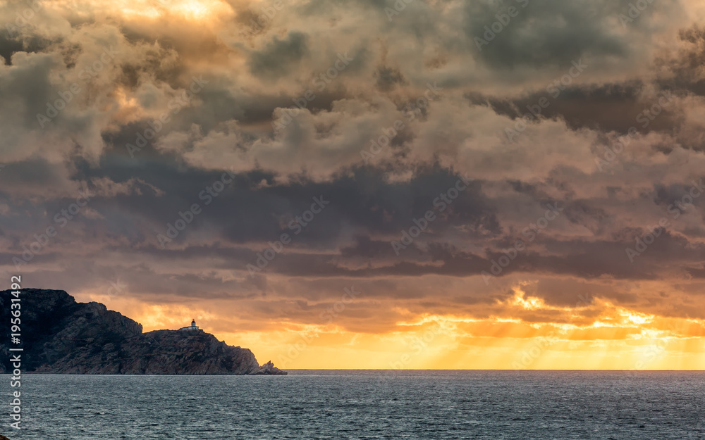 Evening sunrays burst through stormy skies at Revellata in Corsica
