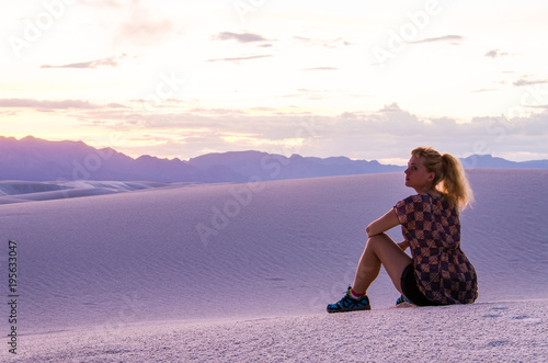 Silhouette of woman watching over White Sand Dunes during sunset