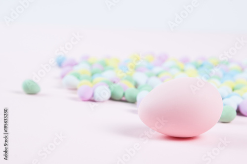 pastel colored easter eggs on a pink background