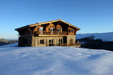 Chalet and snow in peak of mountain landscape