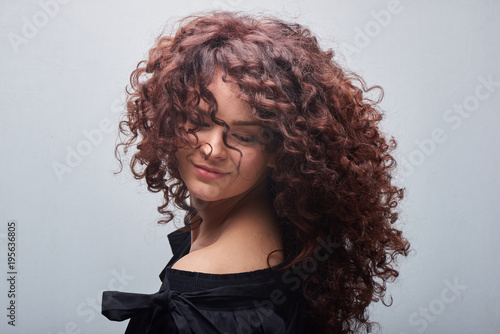 Portrait of young woman with trend curly hair, professional hair coloring