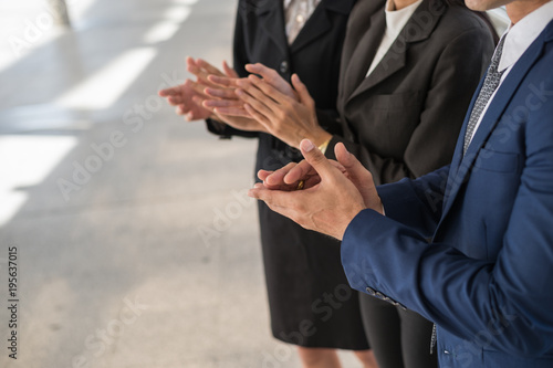 business man and business woman clap their hands to congratulate the signing of an agreement or contract between their companies. success, dealing, greeting and partner concept.