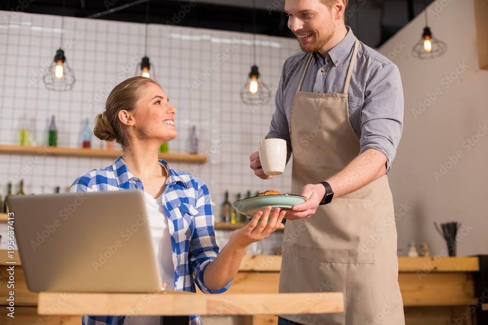 Delighted cheerful woman looking at the waiter Delighted cheerful woman looking at the waiter