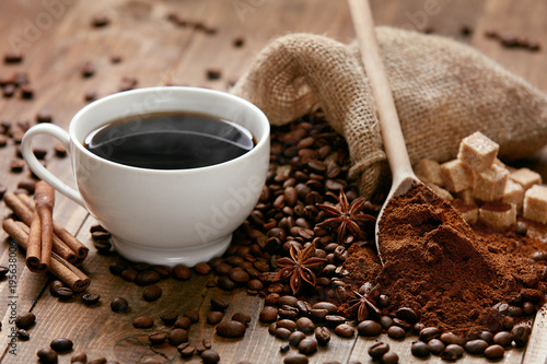 Cup Of Coffee And Coffee Beans On Table.