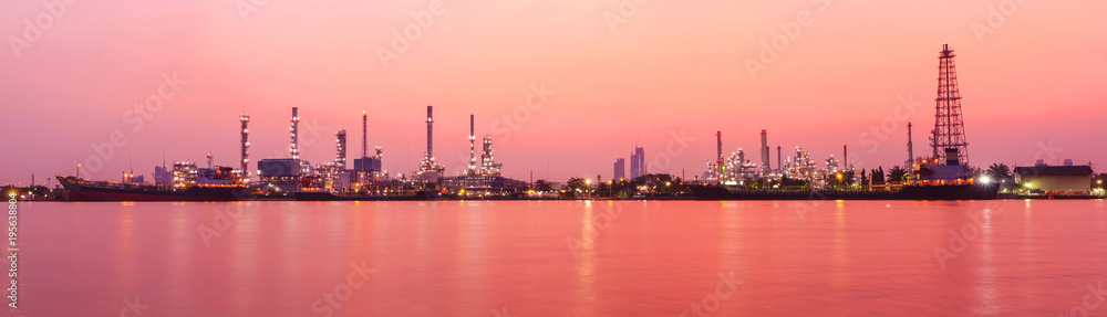 Panorama view of Oil refinery at the river in sunrise time