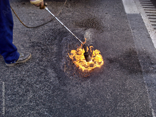 Torch flame and melting surface road