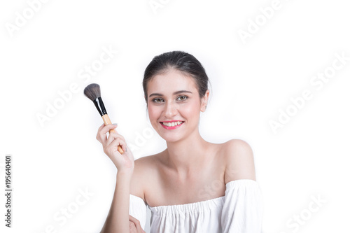 Young beautiful woman with Makeup brush isolated on white backgound.