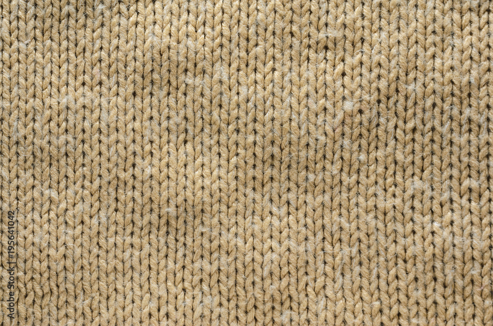 Knit Texture of Beige Wool Knitted Fabric with Regular Pattern. Knit Sweater Blank Background Knit Texture of Beige Wool Knitted Fabric with Regular Pattern. Knit Sweater Blank Background