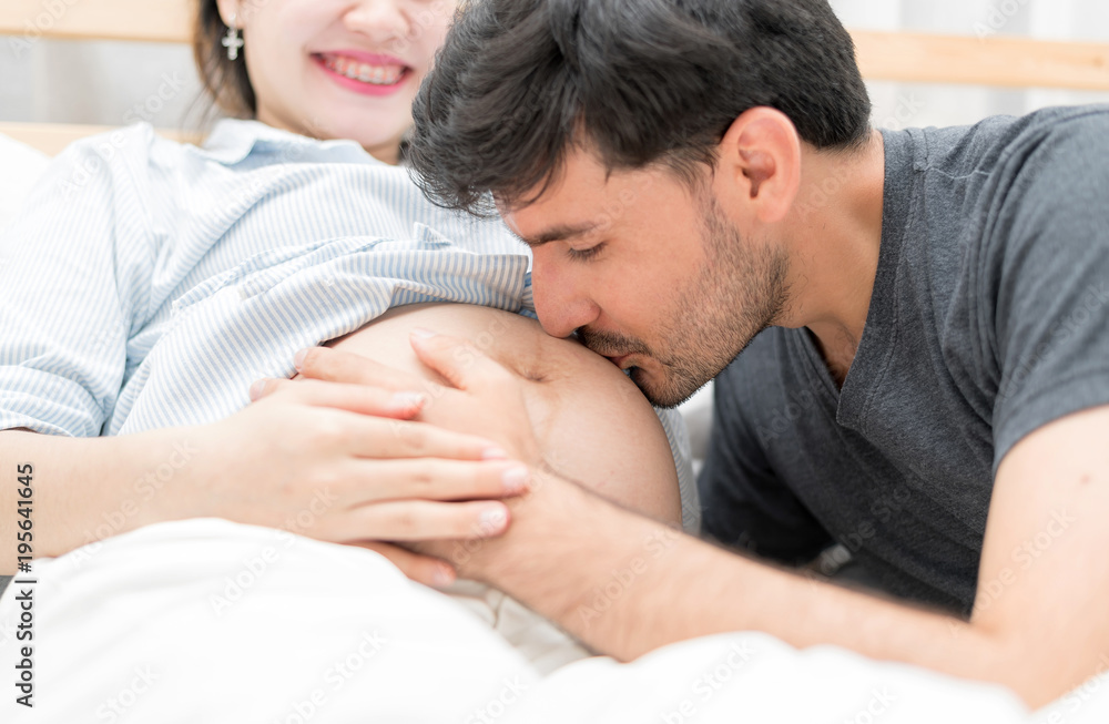 n Selective Focus Of Happy Family Checking New Baby In The Morning.Close Up Of A Beautiful Happy Pregnant Woman With Big Belly. Pregnancy And Motherhood Moment People And Expectation Concept. n Selective Focus Of Happy Family Checking New Baby In The Morning.Close Up Of A Beautiful Happy Pregnant Woman With Big Belly. Pregnancy And Motherhood Moment People And Expectation Concept.