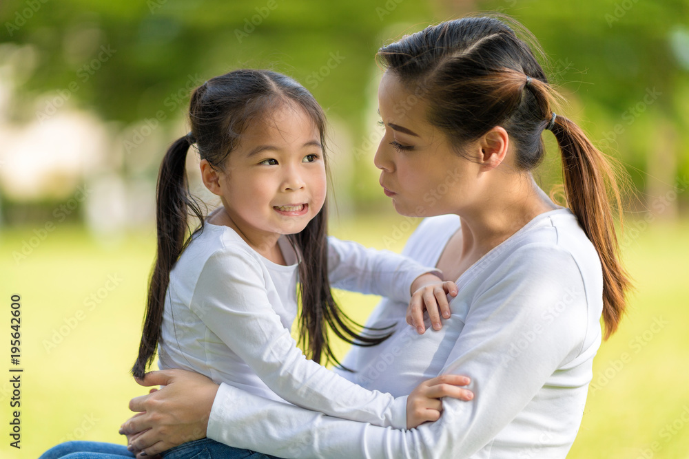 Happy little girl having fun in playground with mother. Happy little girl having fun in playground with mother.