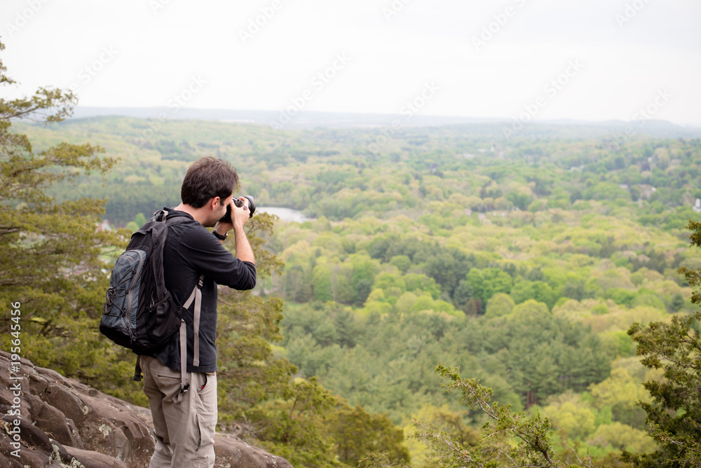 A man photographer hiking up a mountain
