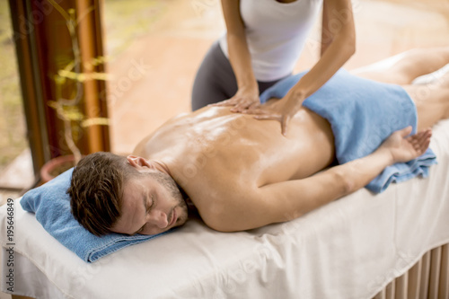 Young man having massage in...