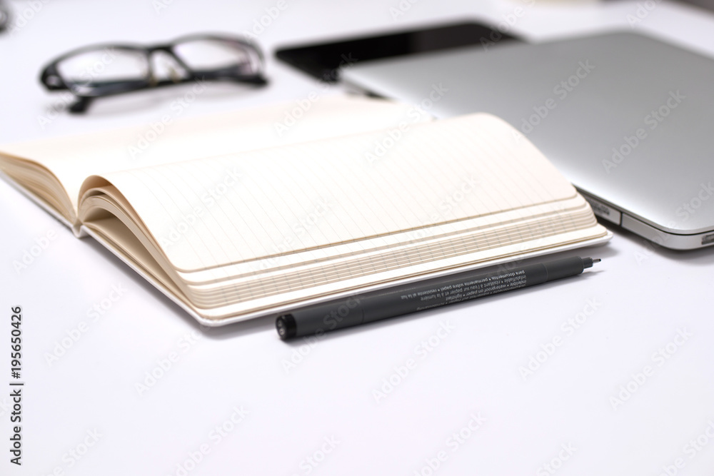 Notebook, pen and Laptop on White background Notebook, pen and Laptop on White background