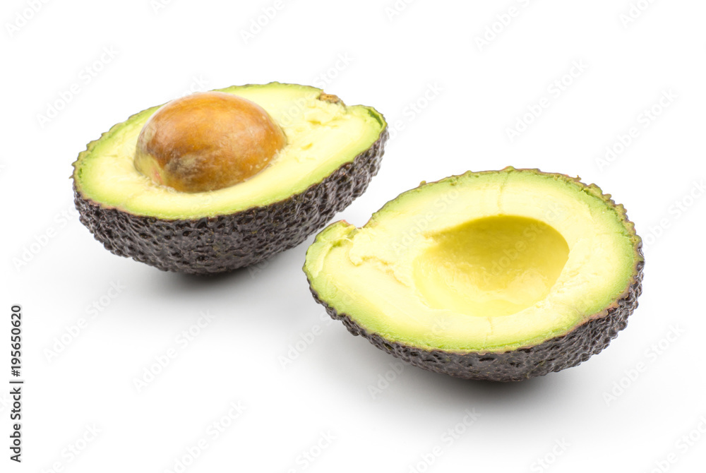 Sliced green brown avocado isolated on white background two ripe alligator pear halves with a seed.