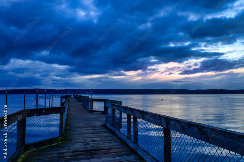 dark blue storm clouds over wooden dock
