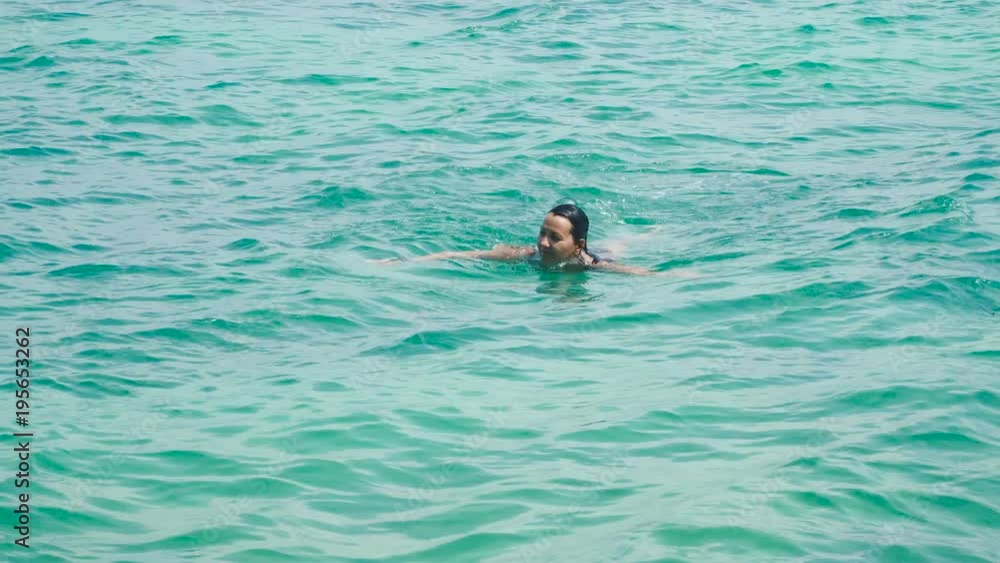 Pretty woman swimming in the sea. Relaxing on vacation Pretty woman swimming in the sea. Relaxing on vacation