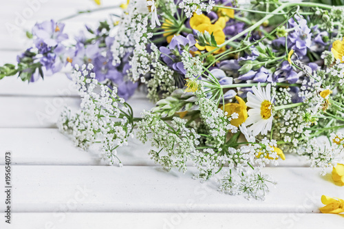 Fototapeta Naklejka Na Ścianę i Meble -  colorful wild summer flower bouquet on white table
