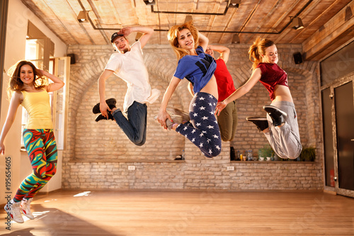 Group of young people jumping together