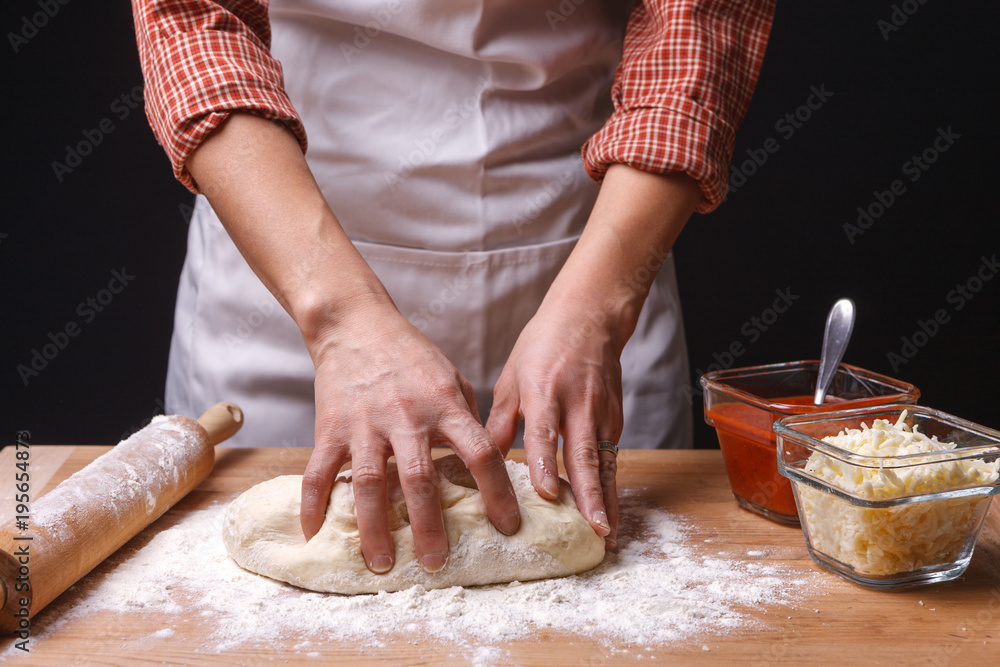 Woman kneads pizza dough. Woman kneads pizza dough.