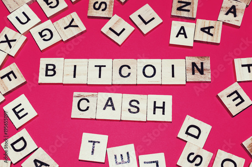 Wooden blocks on a red background spelling words Bitcoin Cash