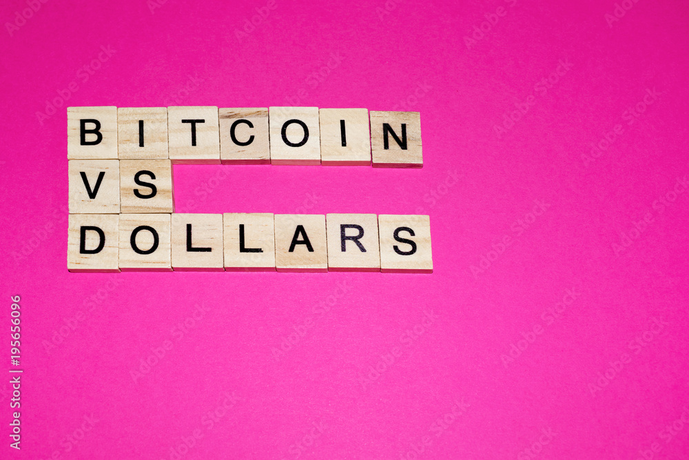 Wooden blocks on a pink background spelling words Bitcoin vs dollars Wooden blocks on a pink background spelling words Bitcoin vs dollars