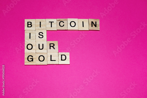 Wooden blocks on a pink background spelling words Bitcoin Is Our Gold