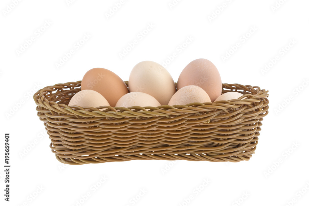 chicken eggs in a wicker basket isolated on a white background chicken eggs in a wicker basket isolated on a white background