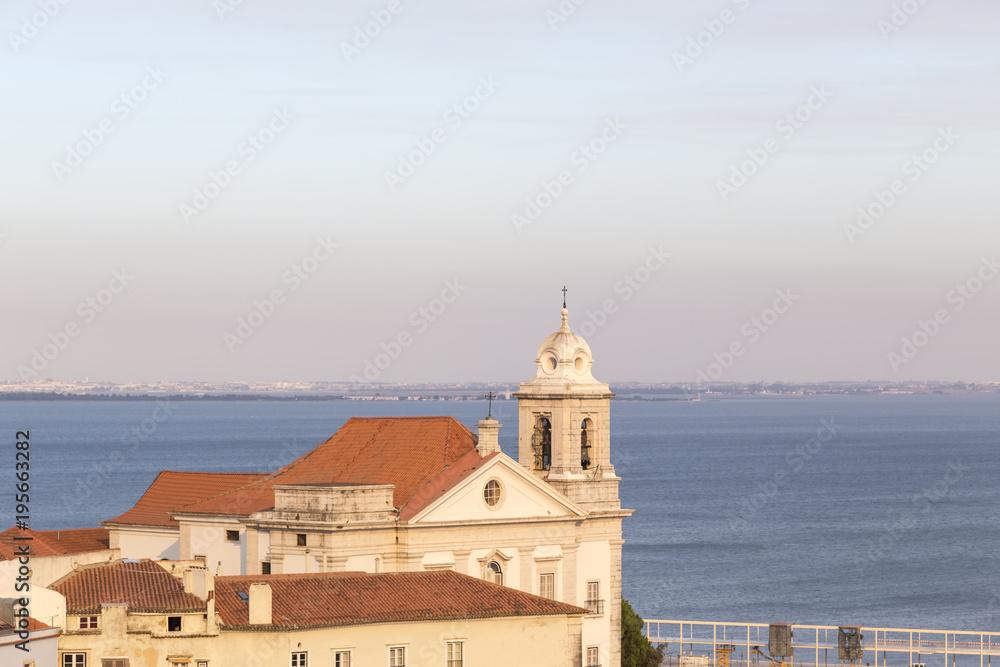 Estuary of the river Tajo from the upper section of Lisbon, Portugal, church in the foreground, next to other buildings