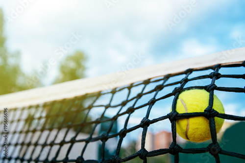 Close-up photo of tennis ball hitting to net. Sport concept. © Maksym Azovtsev