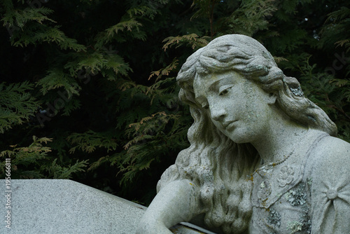 gravestones with stone angels and women tombstones