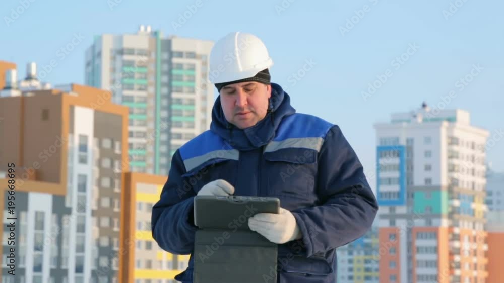 Foreman with tablet computer at major construction project Foreman with tablet computer at major construction project