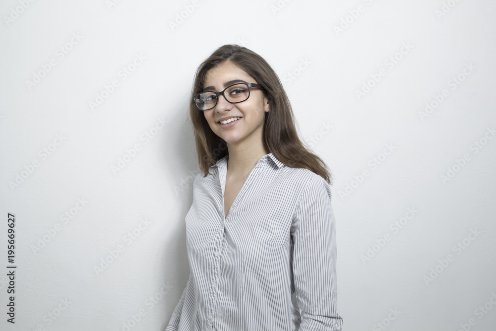 A happy, successful, cheerful indian girl in glasses looks at the camera. A happy, successful, cheerful indian girl in glasses looks at the camera.