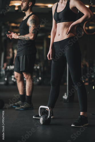 Wallpaper Mural Young woman and man doing workout in gym Torontodigital.ca