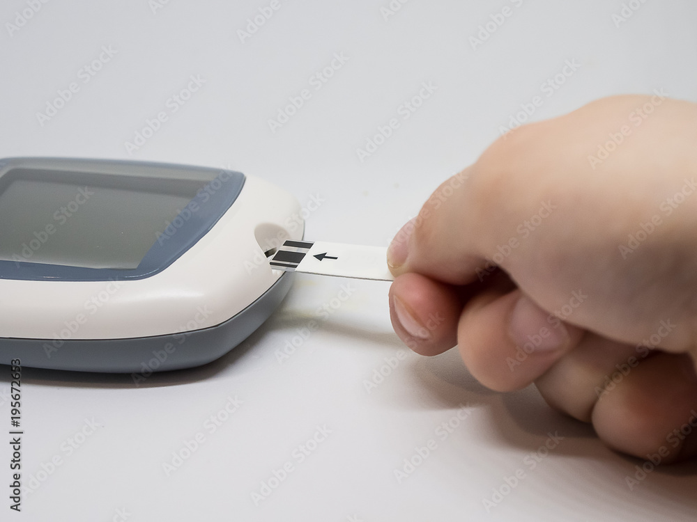 Woman's hand. children's hands doing sugar test on a glucometer isolated on white background Woman's hand. children's hands doing sugar test on a glucometer isolated on white background