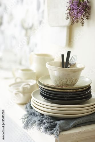 Close-up of Stack of Dishes on Sideboard in Dining Room