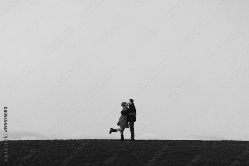 A Couple Kiss on a Hill in Edinburgh at Night A Couple Kiss on a Hill in Edinburgh at Night