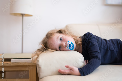Young tired girl in the sofa