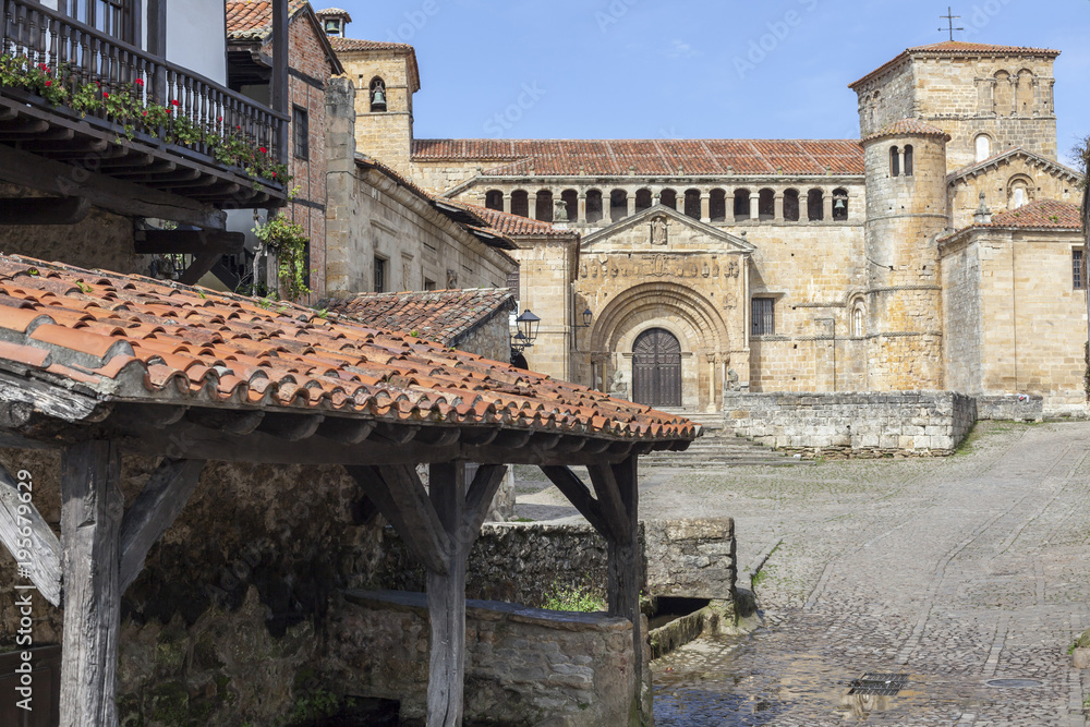 Ancient street view with Collegiate church, Colegiata of Santa Juliana, romanesque style in the touristic village of Santillana del Mar, province Santander, Cantabria, Spain.